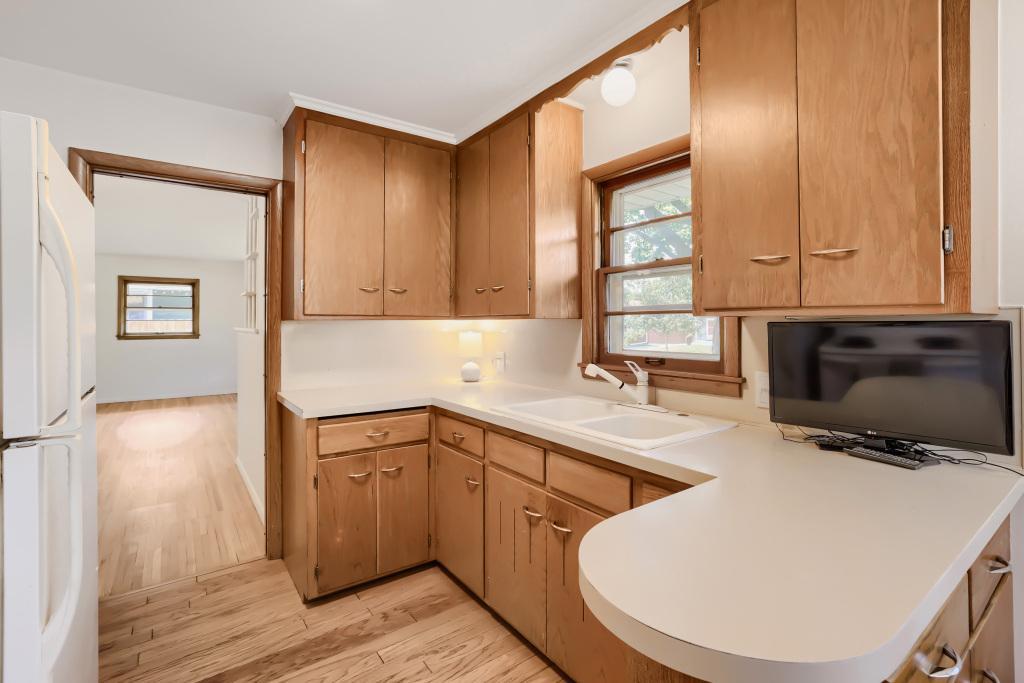 Small but mighty kitchen space! Wood cabinets and neutral countertops.