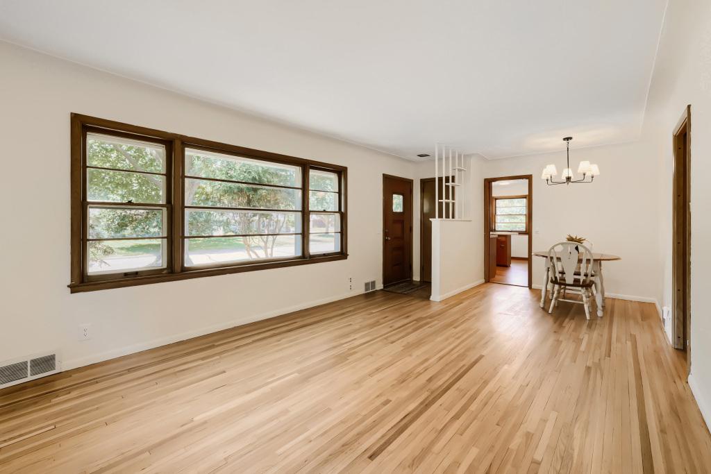 Gorgeous wood floors were recently professionally refinished, fresh paint and a new light fixture brighten up this wonderful living room.