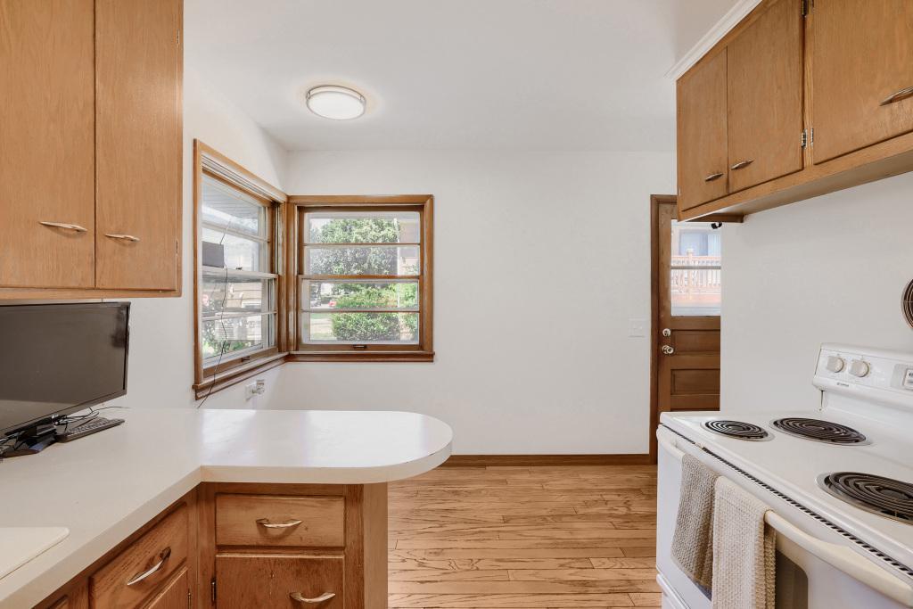 Kitchen area with side door that leads to garage and driveway