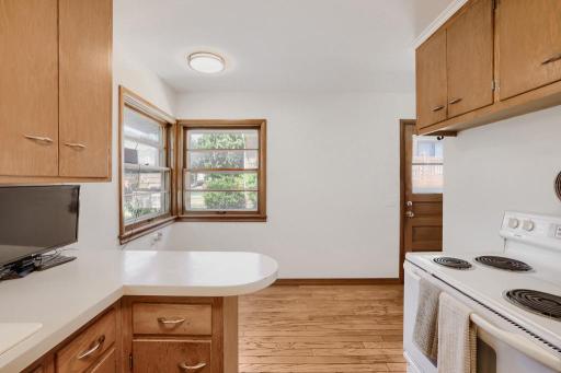 Kitchen area with side door that leads to garage and driveway