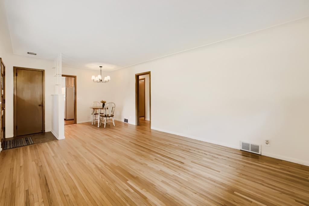 Main floor living room and dining space. Fresh paint and newly refinished wood floors.