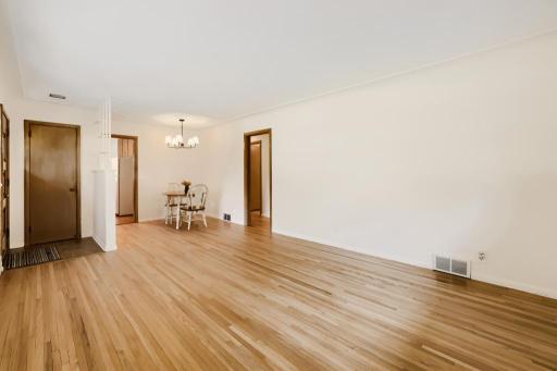 Main floor living room and dining space. Fresh paint and newly refinished wood floors.