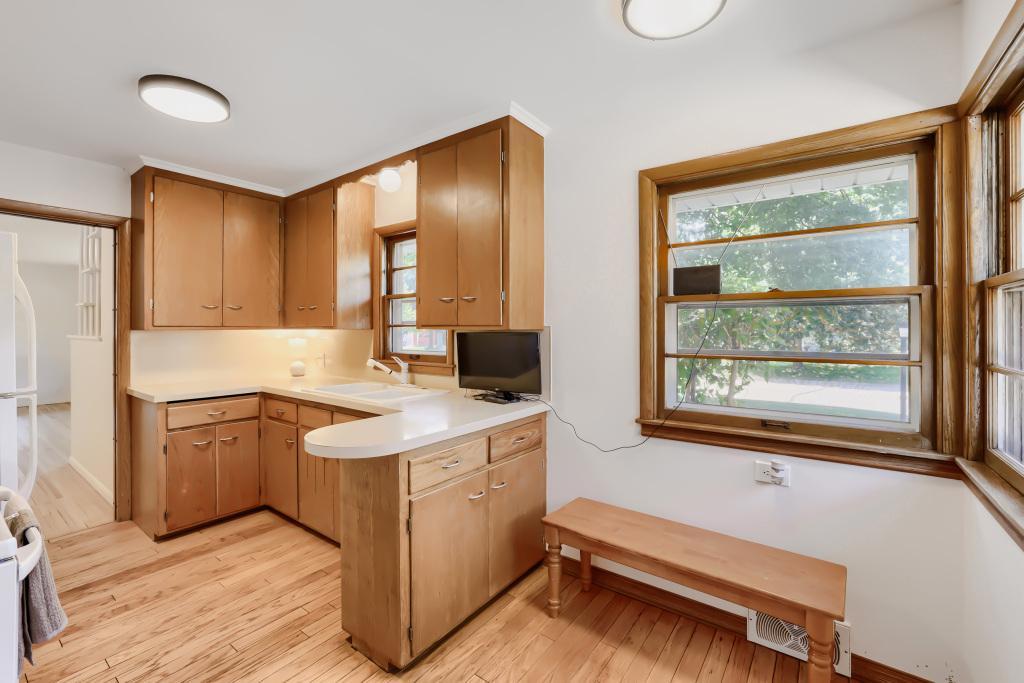 Kitchen with wood cabinets and room for small dining table. Freshly painted!