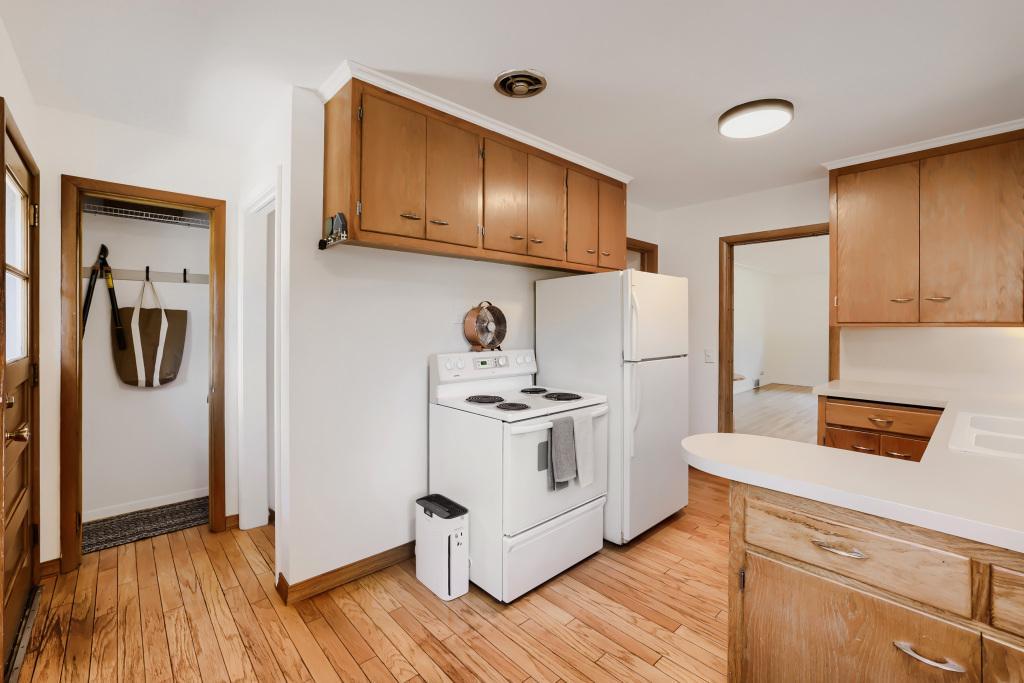 Kitchen with coat closet and stairs that lead down to lower level