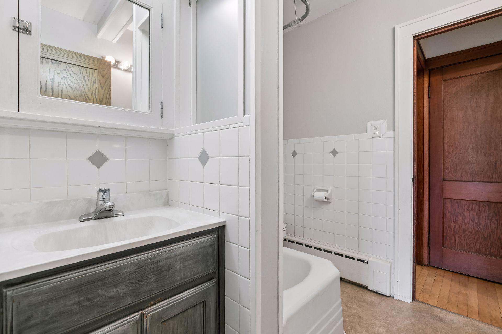 Main floor full bath is a "jack and jill" bath that serves both main floor bedrooms.