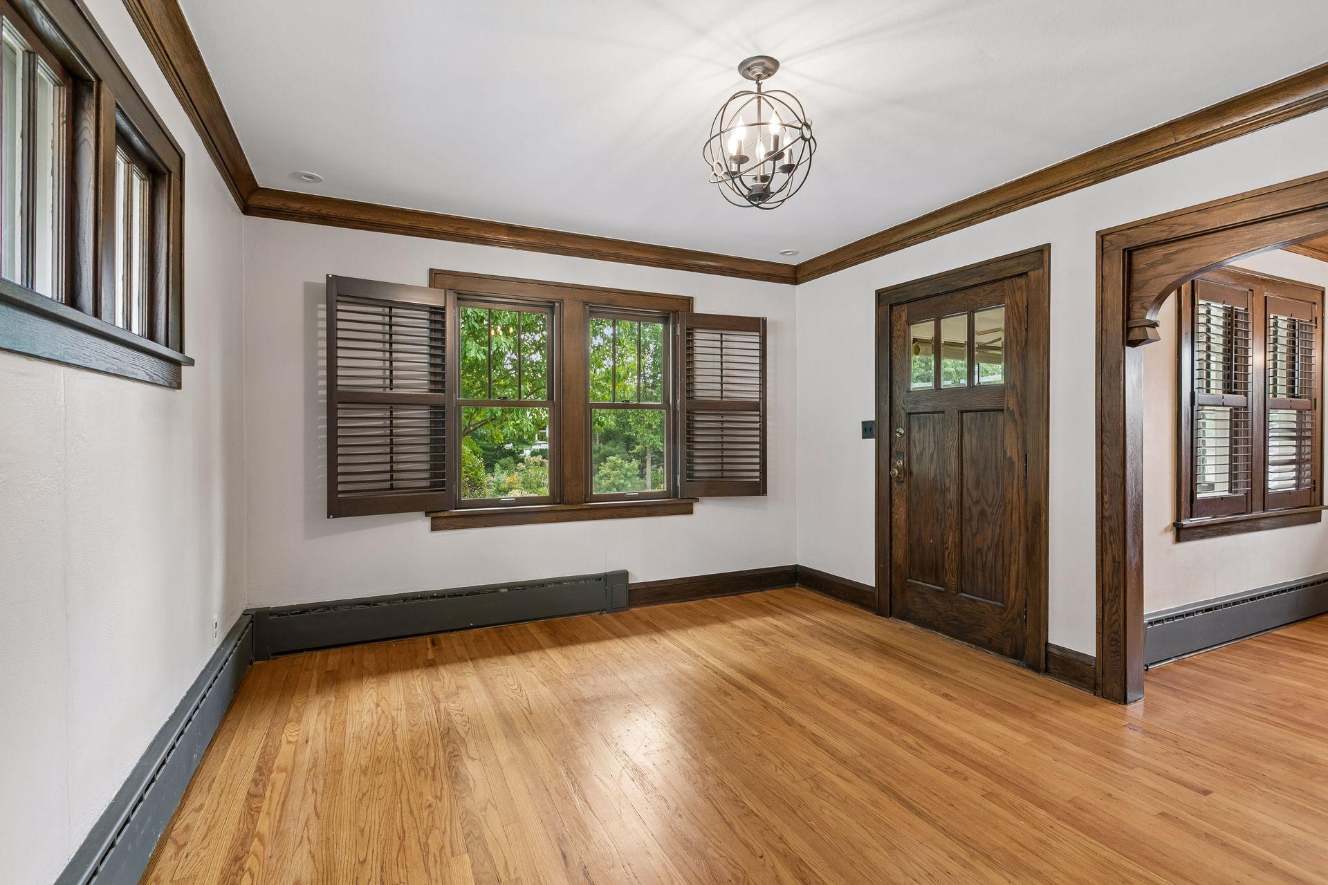 The living room and dining room windows feature custom real wood plantation style shutters.