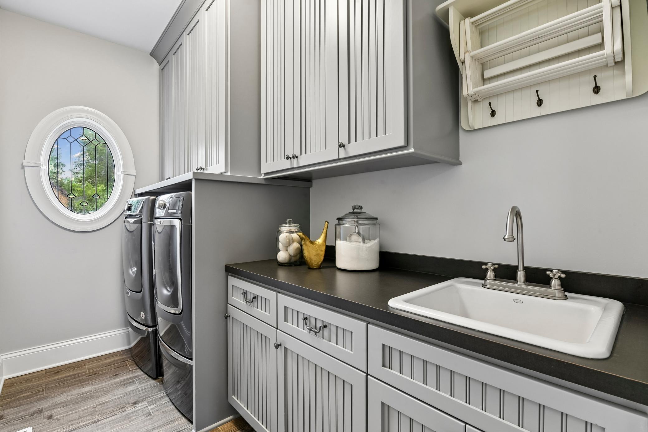 Laundry room with utility sink on upper level