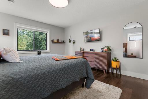 Escape into the private primary bedroom with excellent views of the backyard