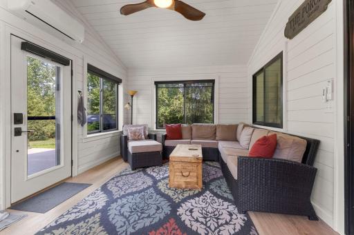 The sunroom is located adjacent to the kitchen and living room