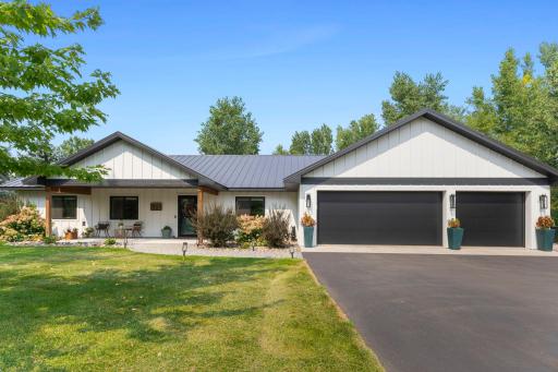 3 car attached garage with inviting front porch and paver walk-way