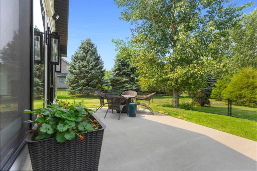 The concrete patio in the fenced-in backyard is a great spot to relax