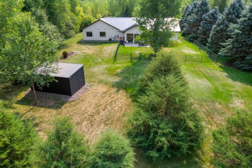 Spacious backyard with large storage shed and great tree coverage