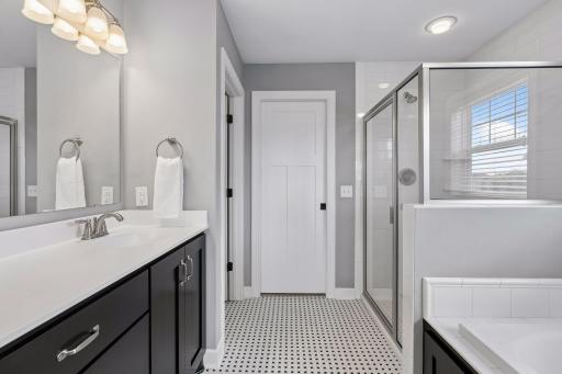 Beautiful detailing in the primary bath with a separate tub and shower