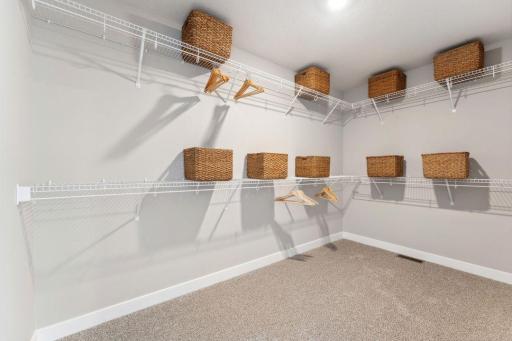 Primary suite with massive walk in closet and private bathroom. Jameson floor plan. Photo of previously built home; finishes, selections, colors, and floorplan to vary.