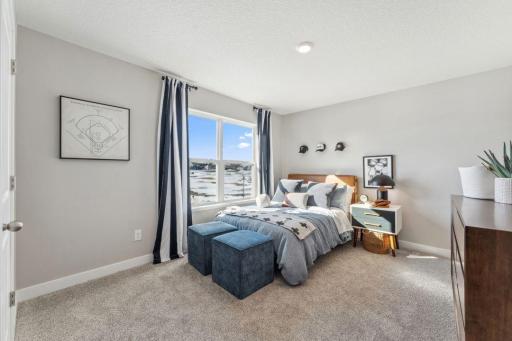 One of the MASSIVE 4 bedrooms on the upper level. Look at the space and those windows. Jameson floor plan. Photo of previously built home; finishes, selections, colors, and floorplan to vary.