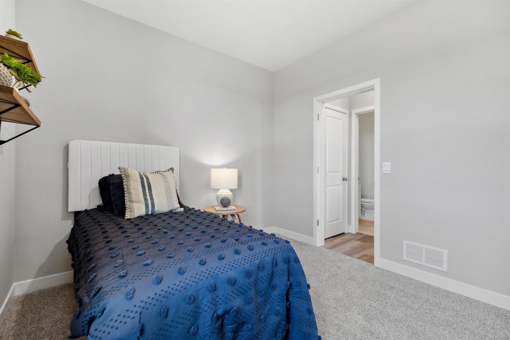 Main Floor Bedroom *Photo is of a past model home, finishes, selections, layout to vary.