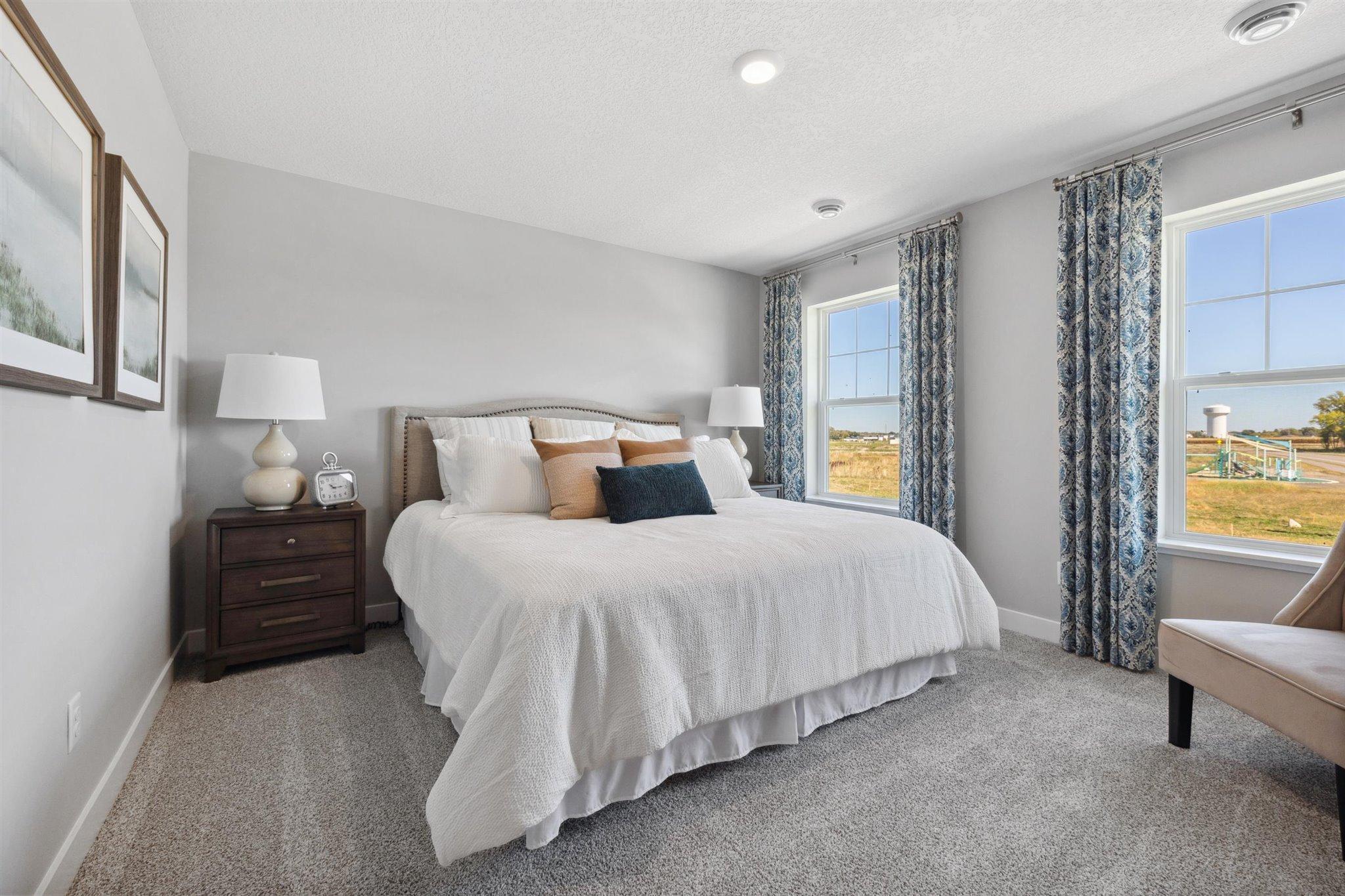 Primary Suite with two closets. *Photo is of a past model home, finishes, selections, layout to vary.