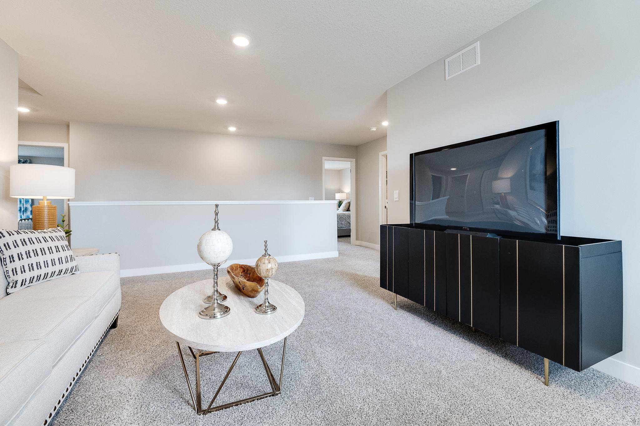 The upstairs loft is sure to become a family favorite hangout spot, close by each of the home's four upper level bedrooms! Photo of model home, color & options may vary.