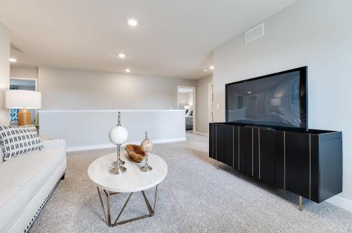 The upstairs loft is sure to become a family favorite hangout spot, close by each of the home's four upper level bedrooms! Photo of model home, color & options may vary.