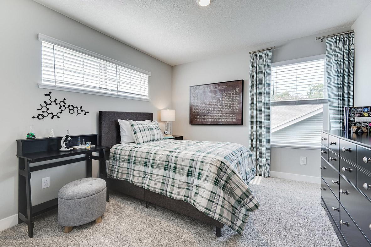 The third bedroom also features a walk-in closet and extra light from multiple windows! Photo of model home, color & options may vary.