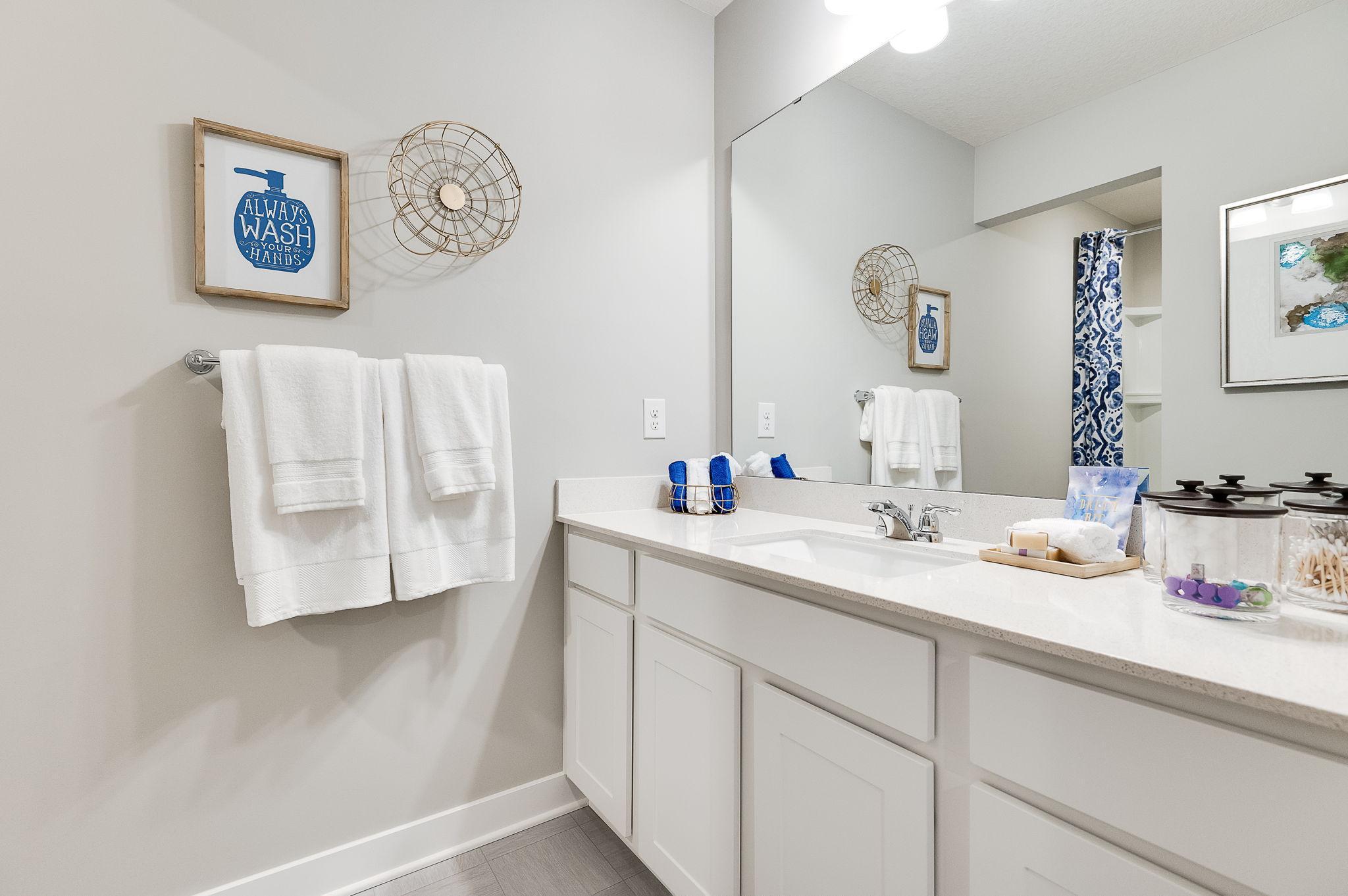 Those bedrooms each have easy access to this deep and spacious bathroom! Photo of model home, color & options may vary.