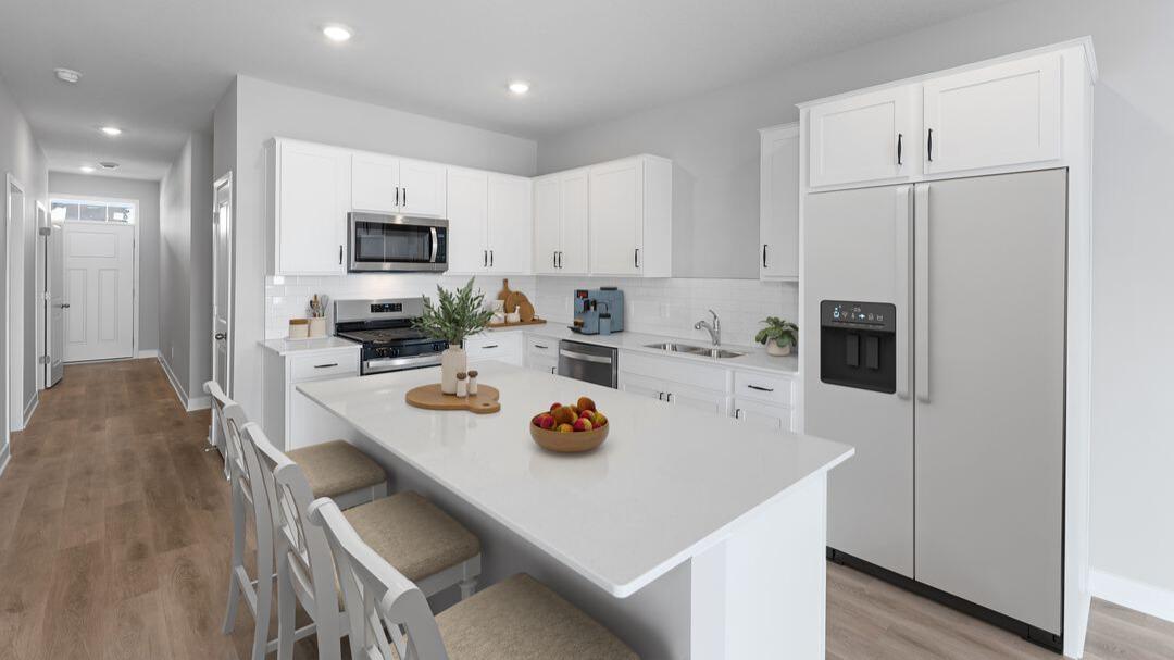Large quartz countertop for additional seating. Virtually staged.