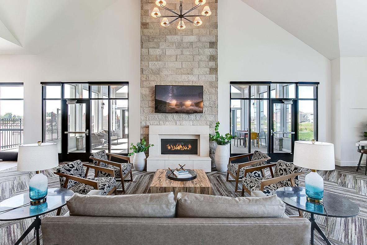 Gorgeous indoor gathering area, complete with waterfall quartz island, fireplace, TV, and plenty of cozy seating. Available for homeowners to reserve for gatherings.