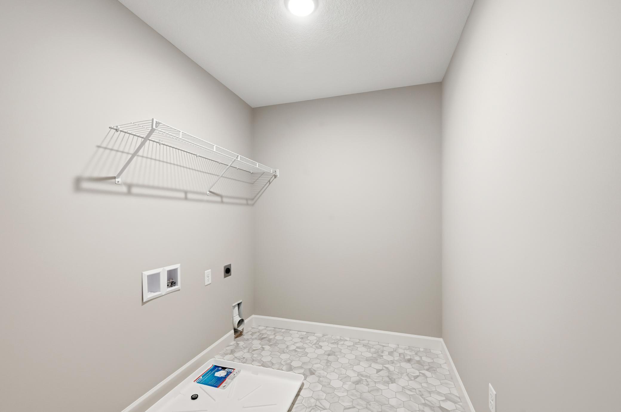 Laundry room - photos of a completed home of the same floorplan. Colors and selections may differ.