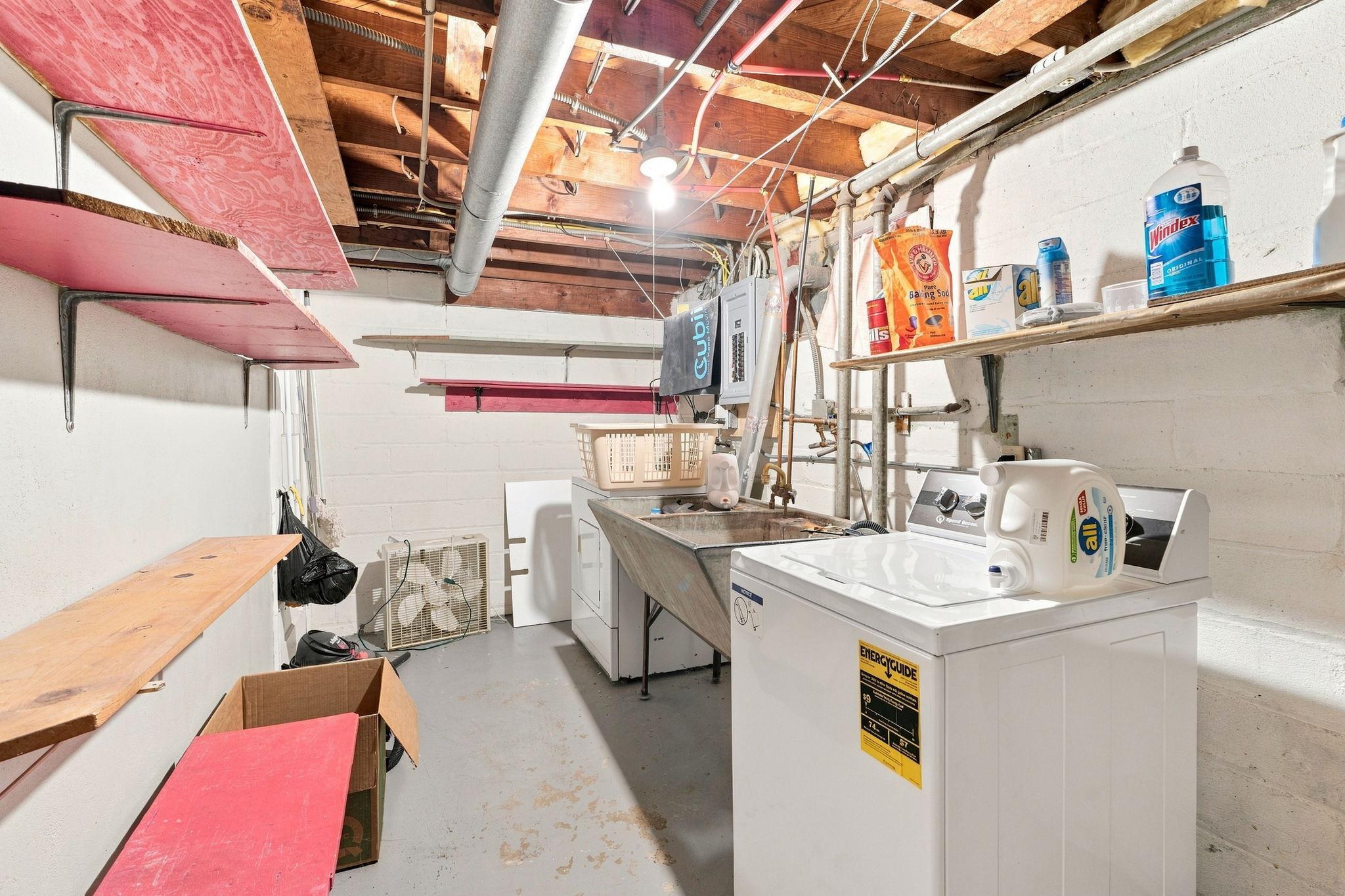 Spacious laundry and mechanical room with storage