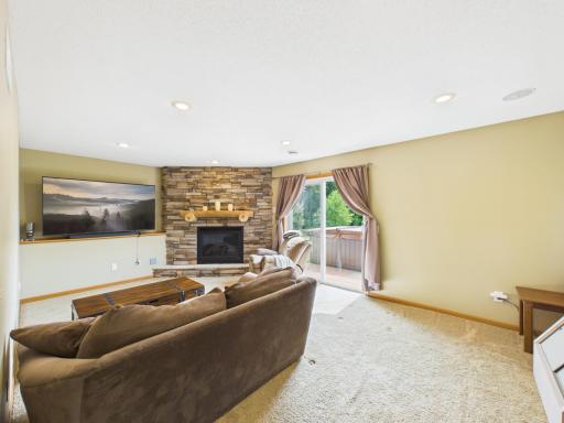 Walk-out lower level family room w/ gas fireplace & access to backyard & hot tub