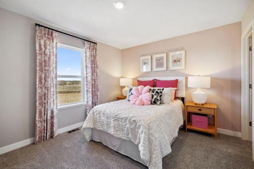One of the 3 additional rooms on upper level with a walk in closet.