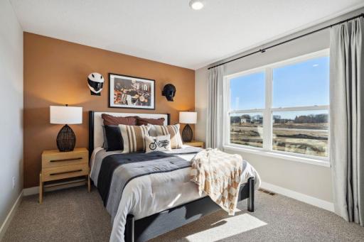 One of the 3 additional rooms on upper level with a walk in closet.
