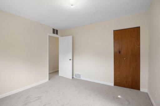 Upper level bedroom has new carpet and has been freshly painted.