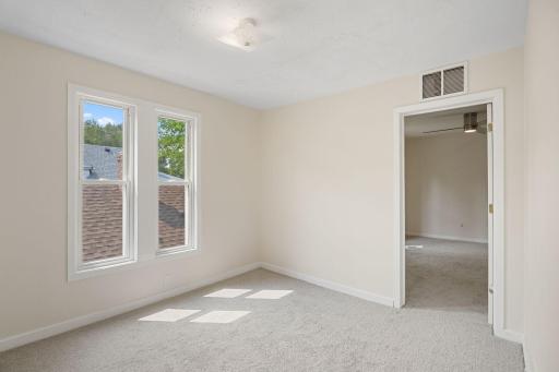 Second upper level bedroom has access to the primary bedroom and has also been freshly painted. Lots of southern light!