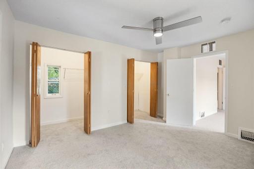 The spacious primary bedroom features an oversized 3' x 13' closet with two access points.