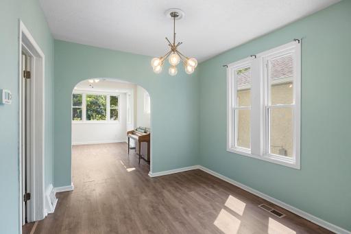 The arched doorway between the living & dining room show a touch of the home's original-era character.