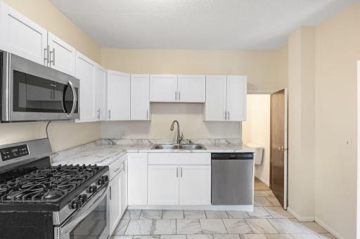 Light, bright kitchen has plenty of counter space for preparing!