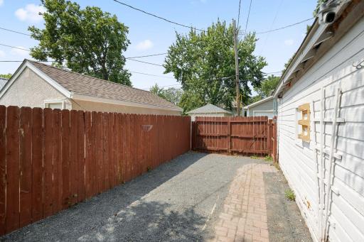 Parking pad adjacent to the garage can be entered through the gate. The gate is the only part of the fence tht belongs to this property. Potential space for an RV, camper, boat/trailer or additional vehicle parking.