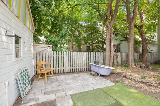 Shaded back yard patio has room for a stand alone fire pit to enjoy the fall evenings that will be coming soon.