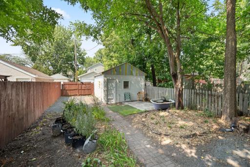 Back yard has established & maturing perennial plantings and patio area. It will be more beautiful in a year or two.