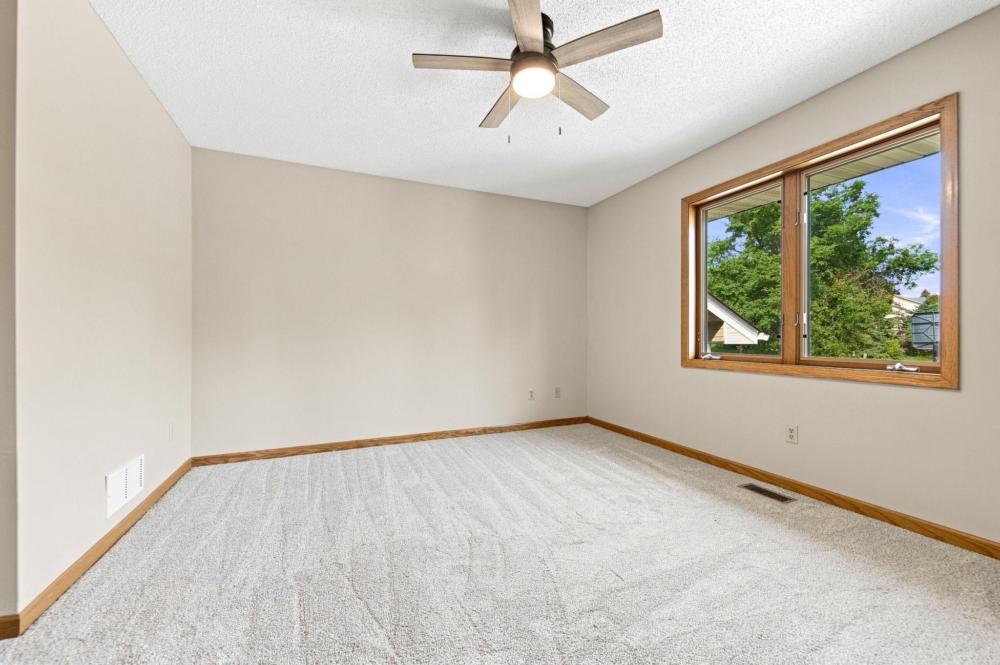 Upper level bedroom 1. All bedrooms have new carpet, paint, and fixtures!