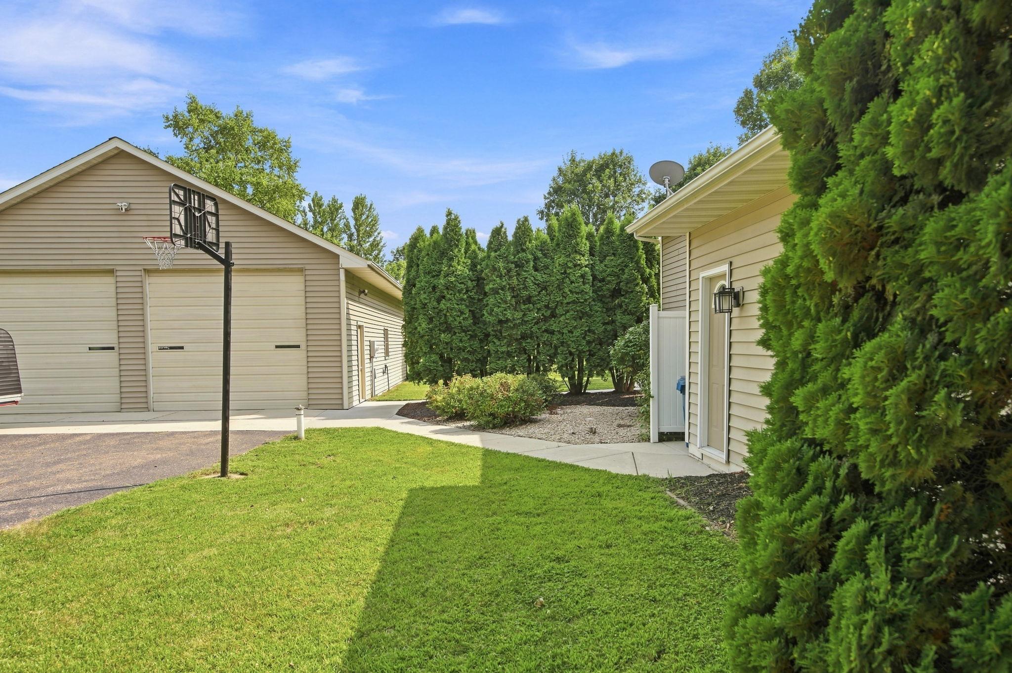 Concrete sidewalk from the detached garage to the attached garage.