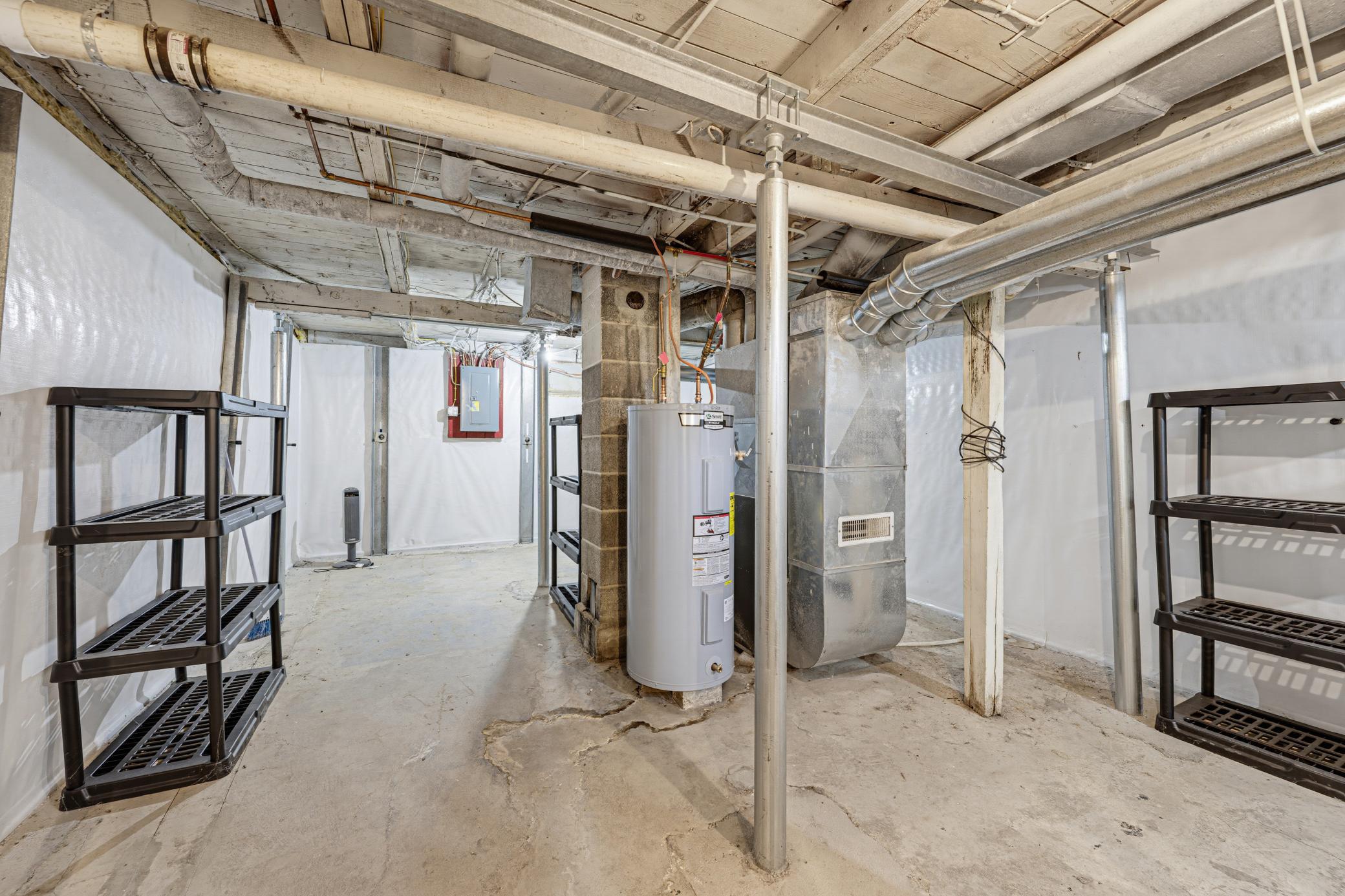 Mechanicals include an electric water heater, a sump pump, and a dehumidifier.
