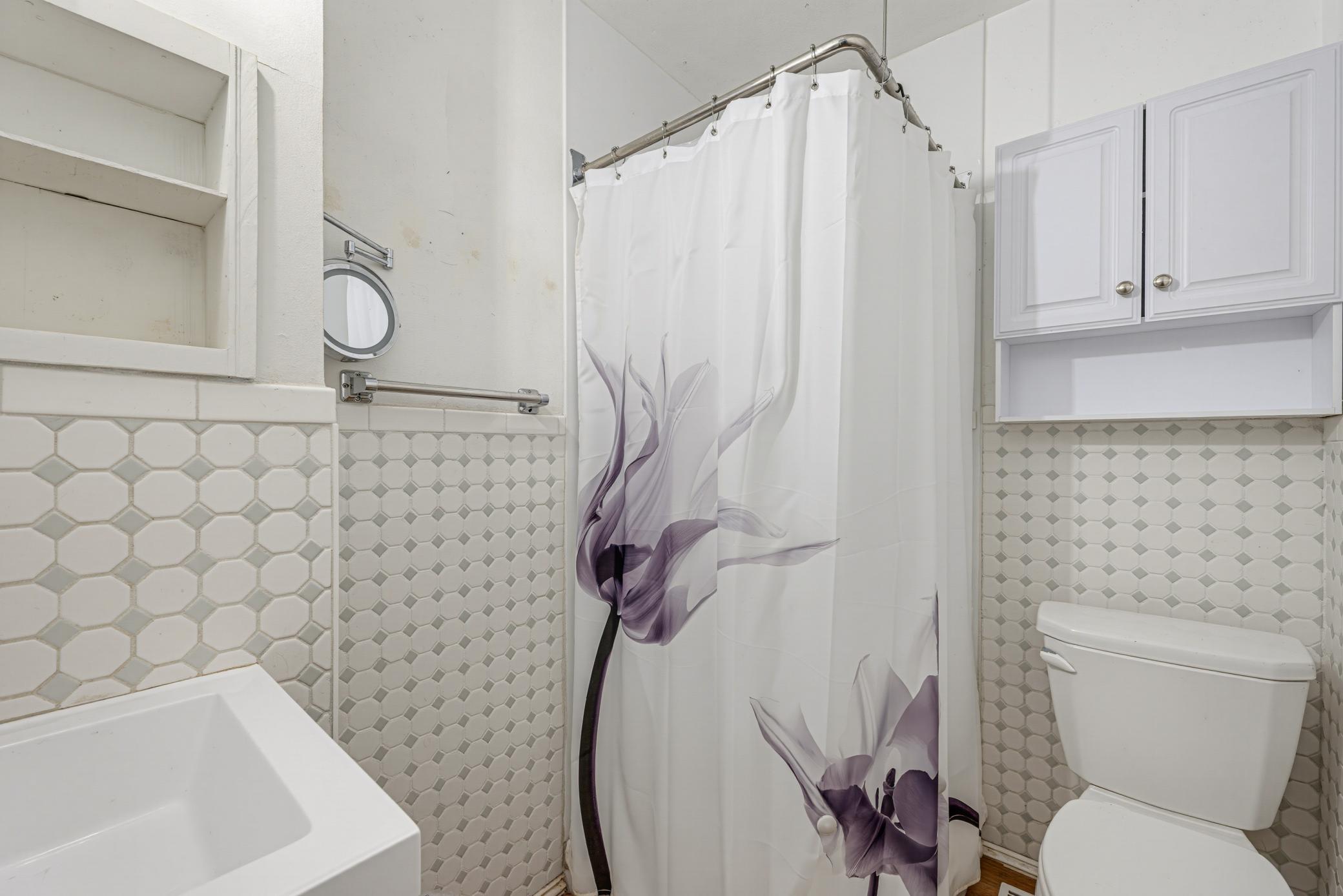 The 3/4 bathroom features tiled walls. The shower was new in 2023.