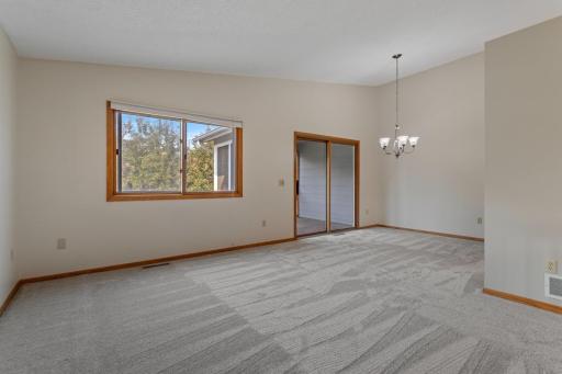Looking towards dining area, patio door leads to screened in porch and deck