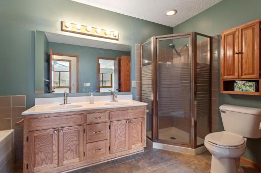 Upper level bath connects to master bedroom and offers a separate tub and shower