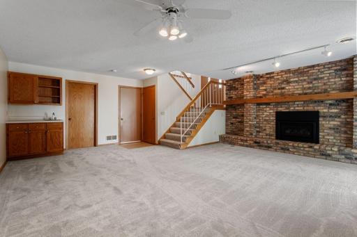 Gas fireplace, open staircase and new carpet throughout