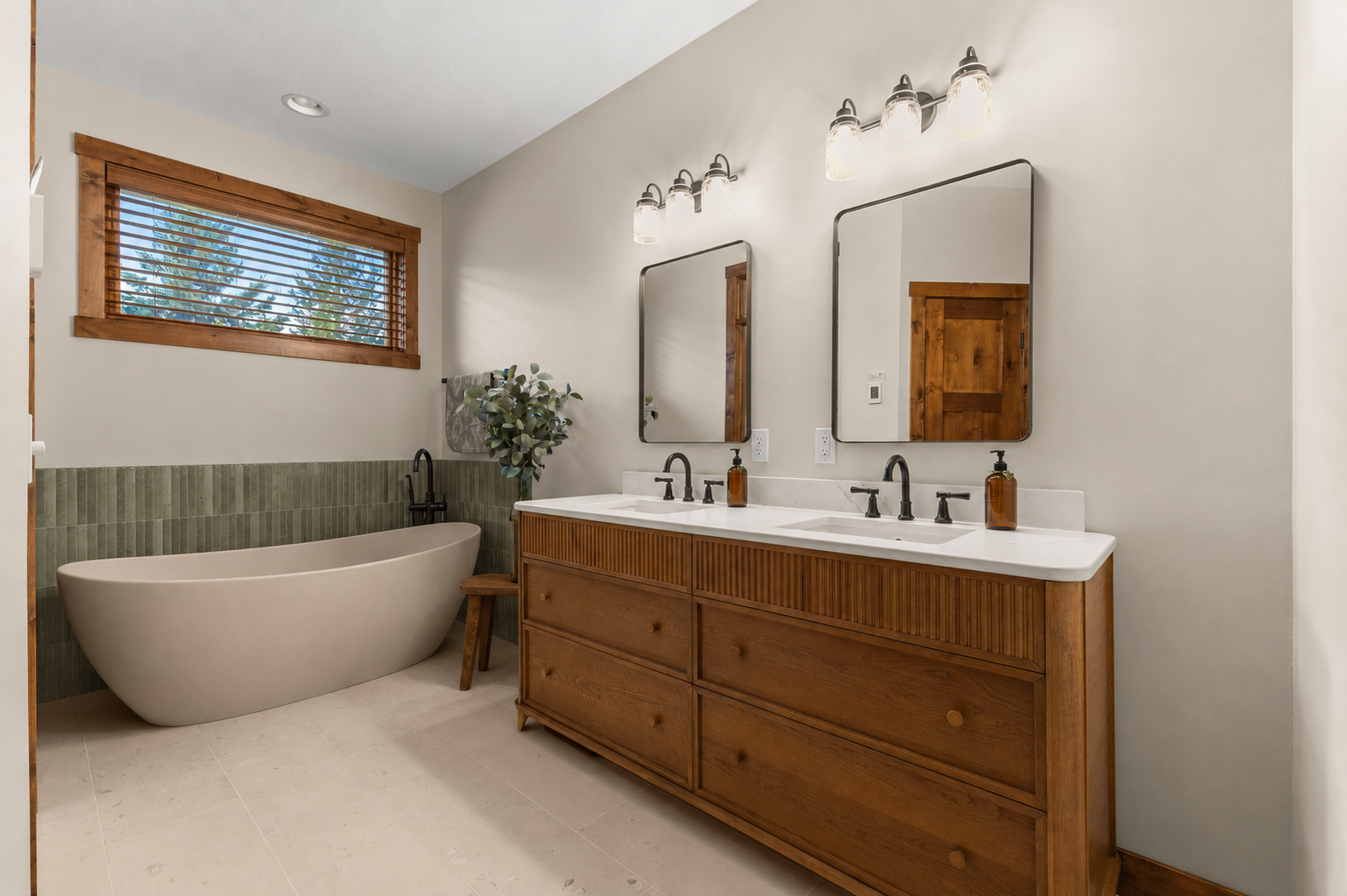 Completely remodeled 2026 spa-like primary bath features a freestanding soaking tub, beautifully tiled shower, heated floors, and custom walk-in closet!