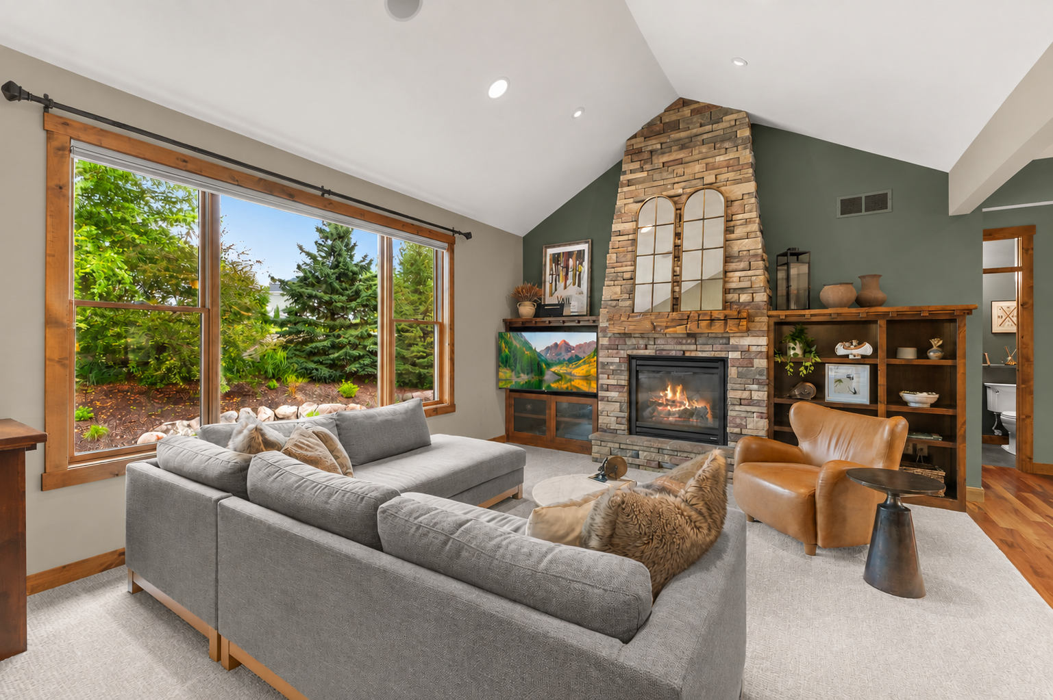 Impressive vaulted great room features a floor-to-ceiling stone fireplace!
