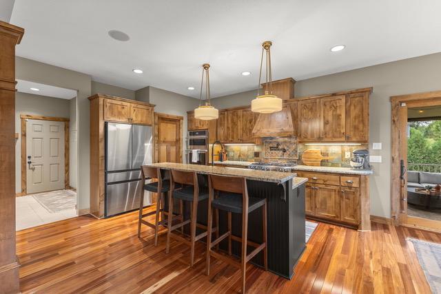 Gourmet kitchen with granite countertops, gas cooktop, double ovens, and plenty of space for entertaining!